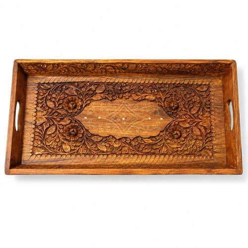 A rectangular hand-carved wooden serving tray with side handles, featuring intricate floral and scrollwork carvings in a warm medium-brown wood finish, shown against a plain white background.